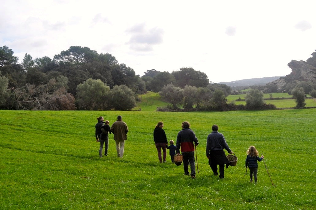 A group of friends walks through the fields of Menorca, foraging for mushrooms.