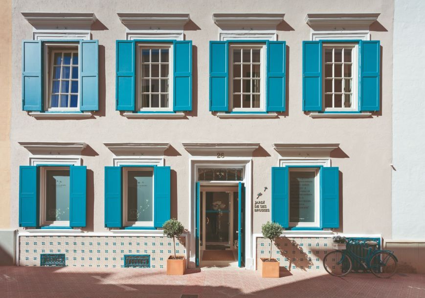 The iconic turquoise shutters of Ses Bruixes Boutique Hotel in Menorca's charming capital city of Mahón.