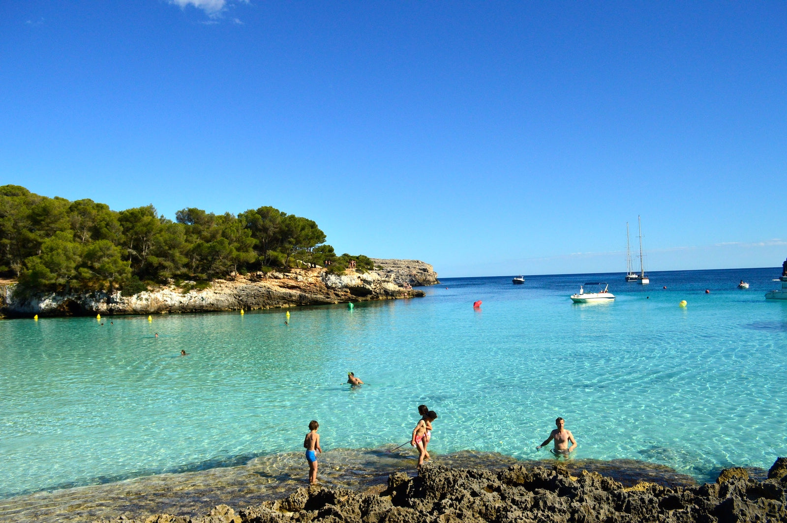 The iconic pine cliffs and crystal clear turqouise waters of Menorca's Cala Turqueta.